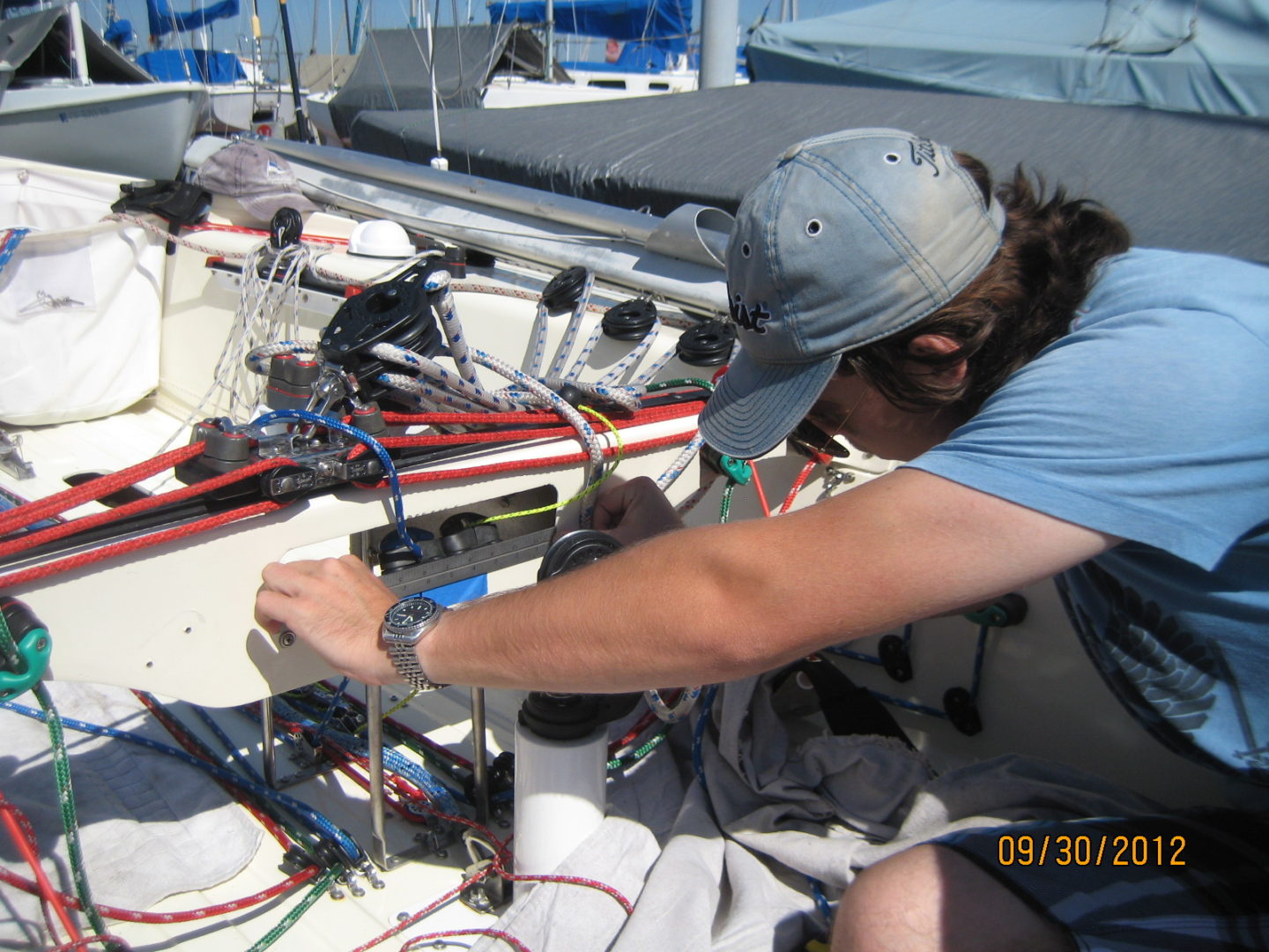 A man working on electronics in the sun.