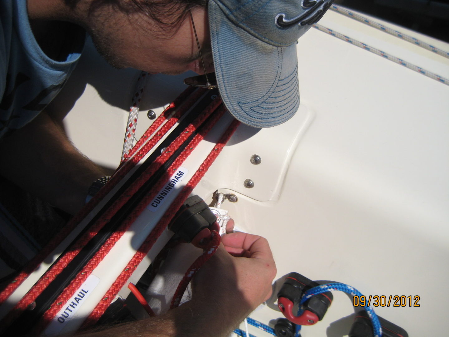 A person working on the side of a boat.