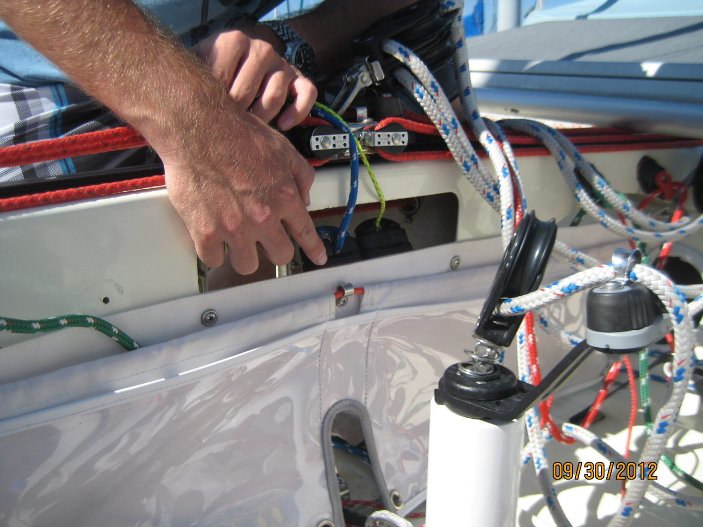 A person is working on the front of a boat.