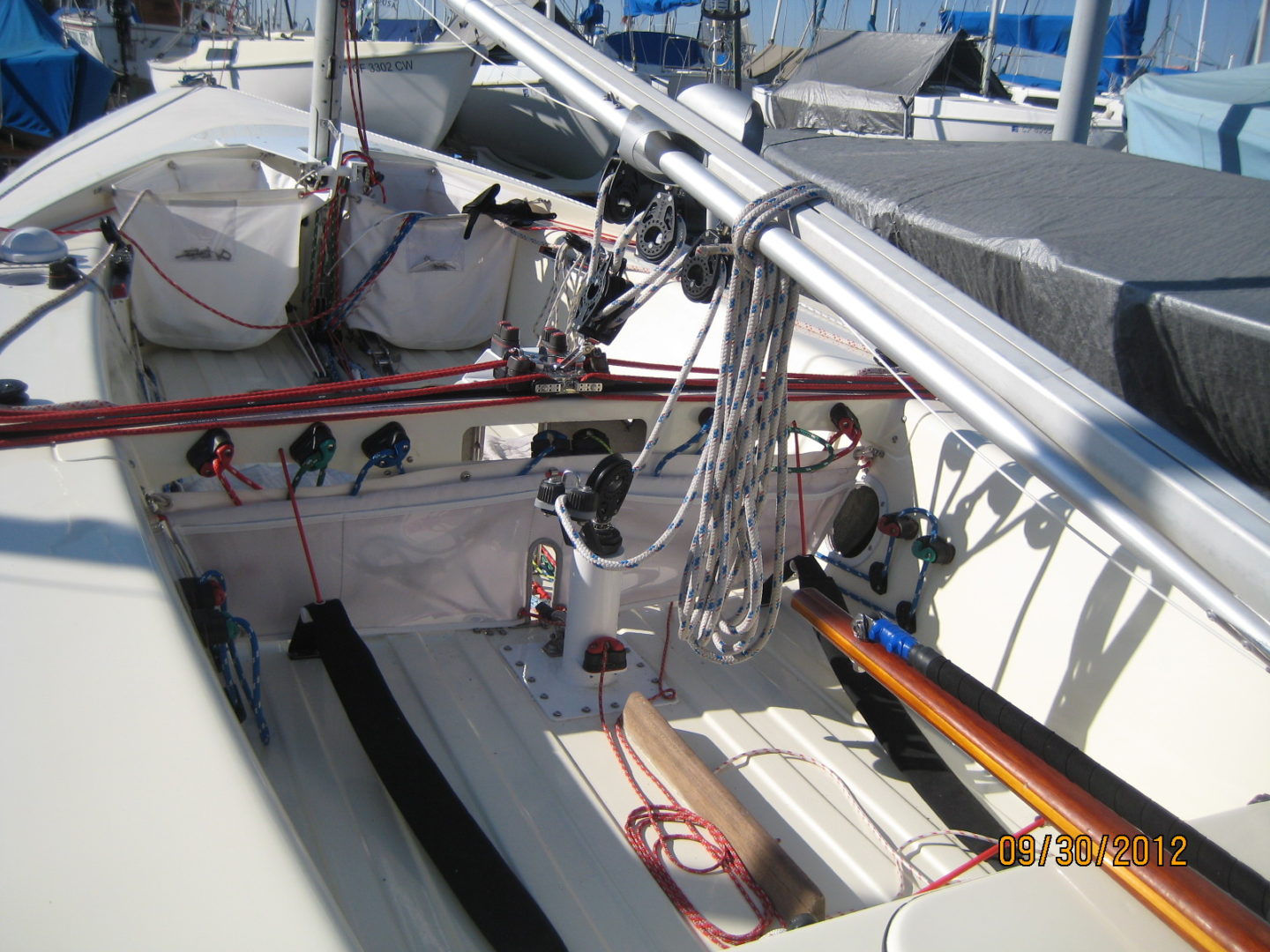 A boat with several ropes on the deck.