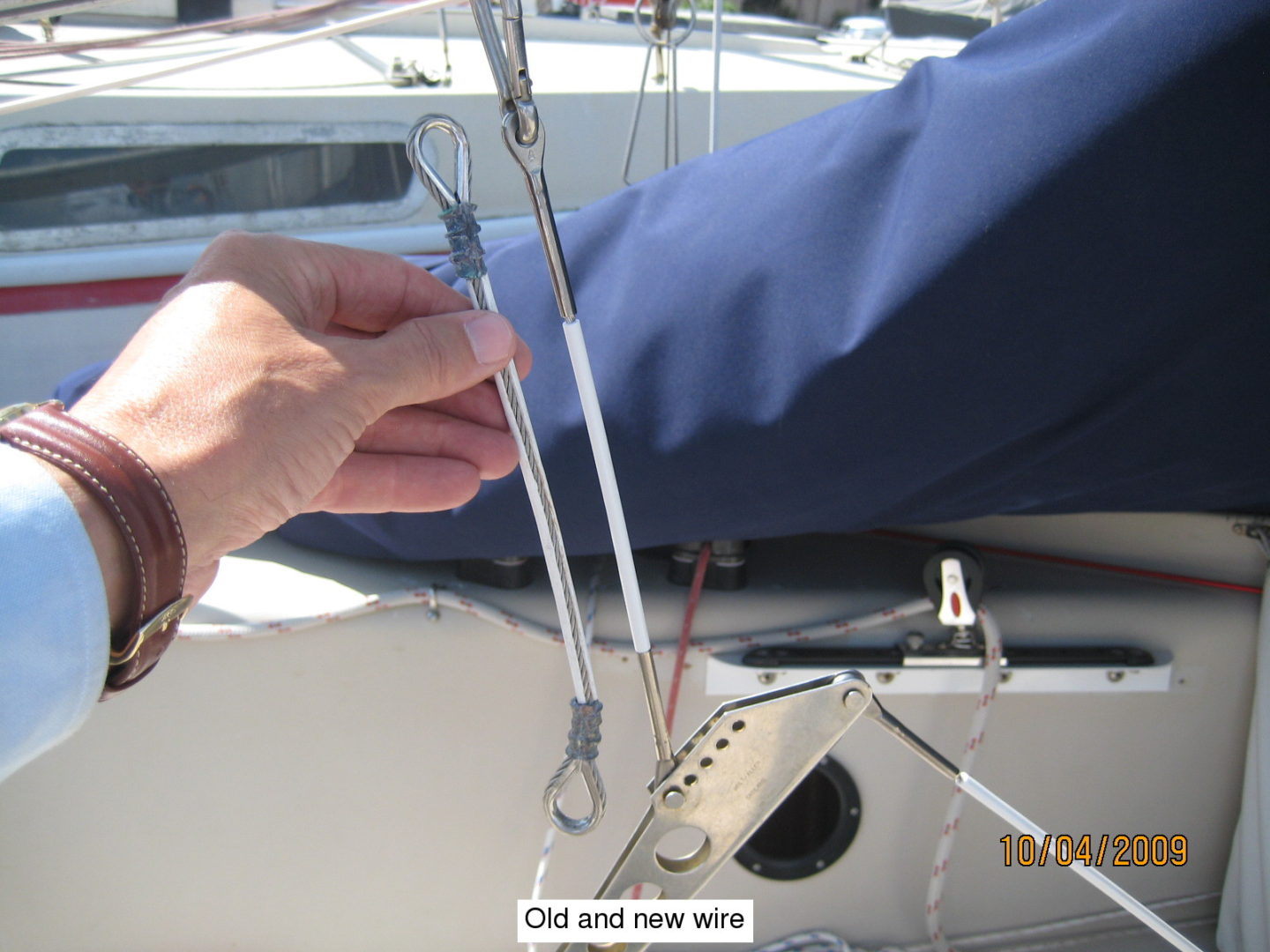 A person holding onto the sail of a boat