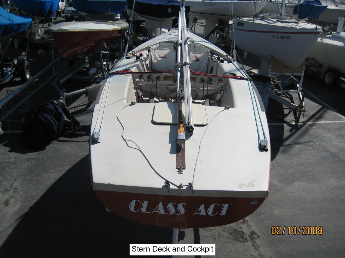 A boat is parked in the dock of a marina.