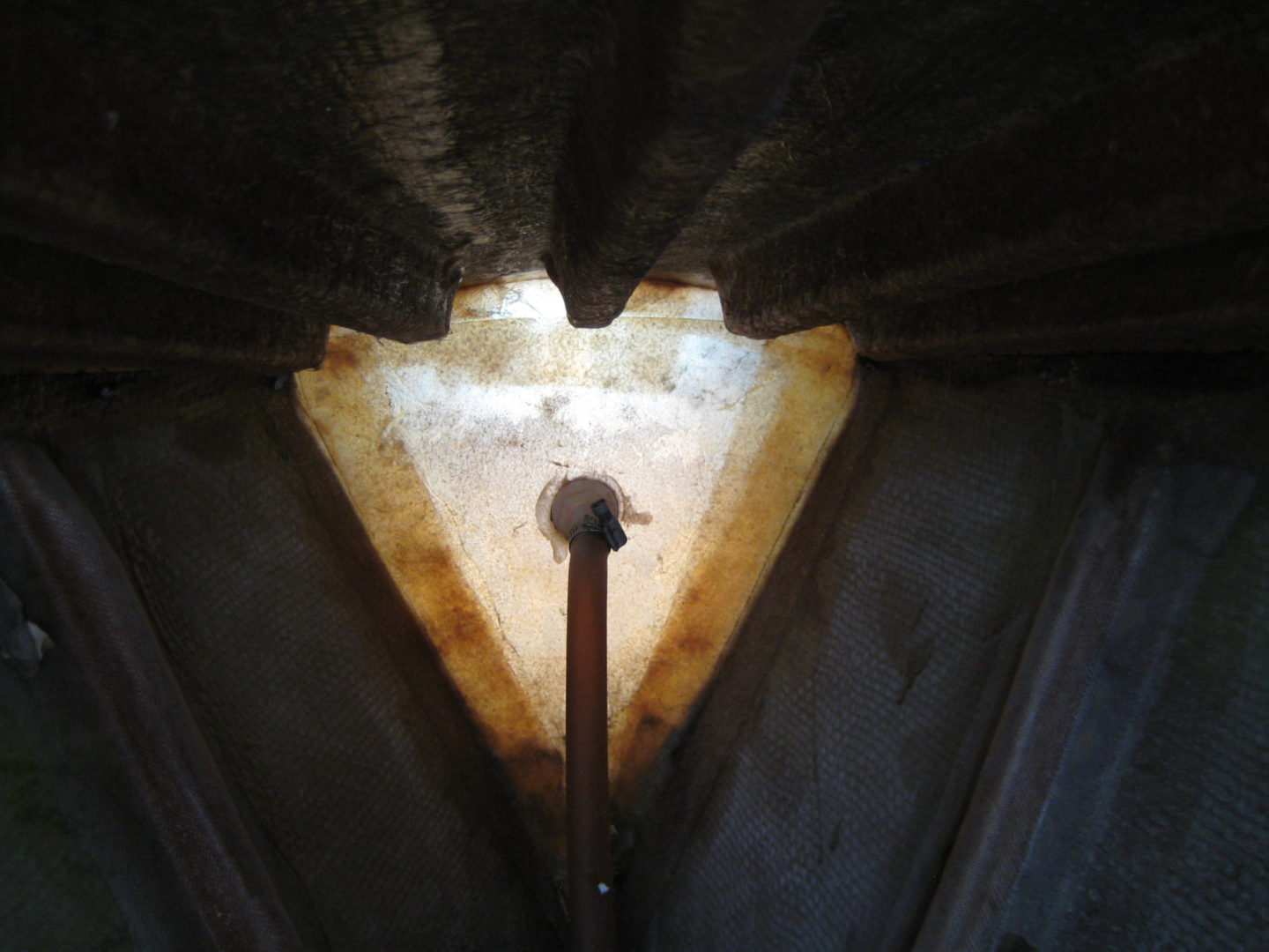 A light is shining through the roof of an old building.