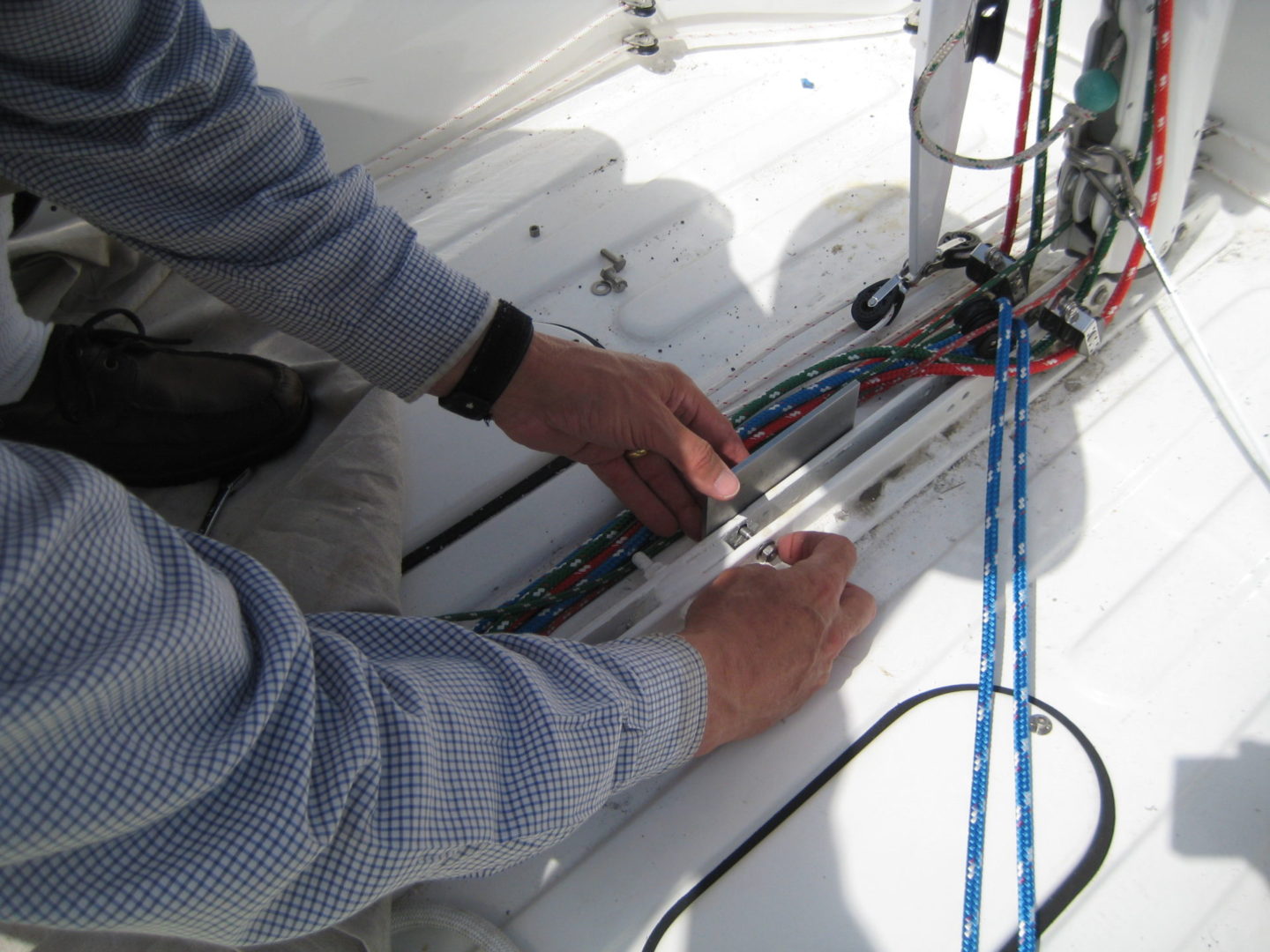 A person working on the side of a boat.