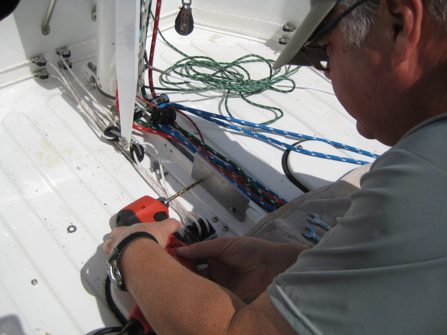 A man working on the side of a boat.