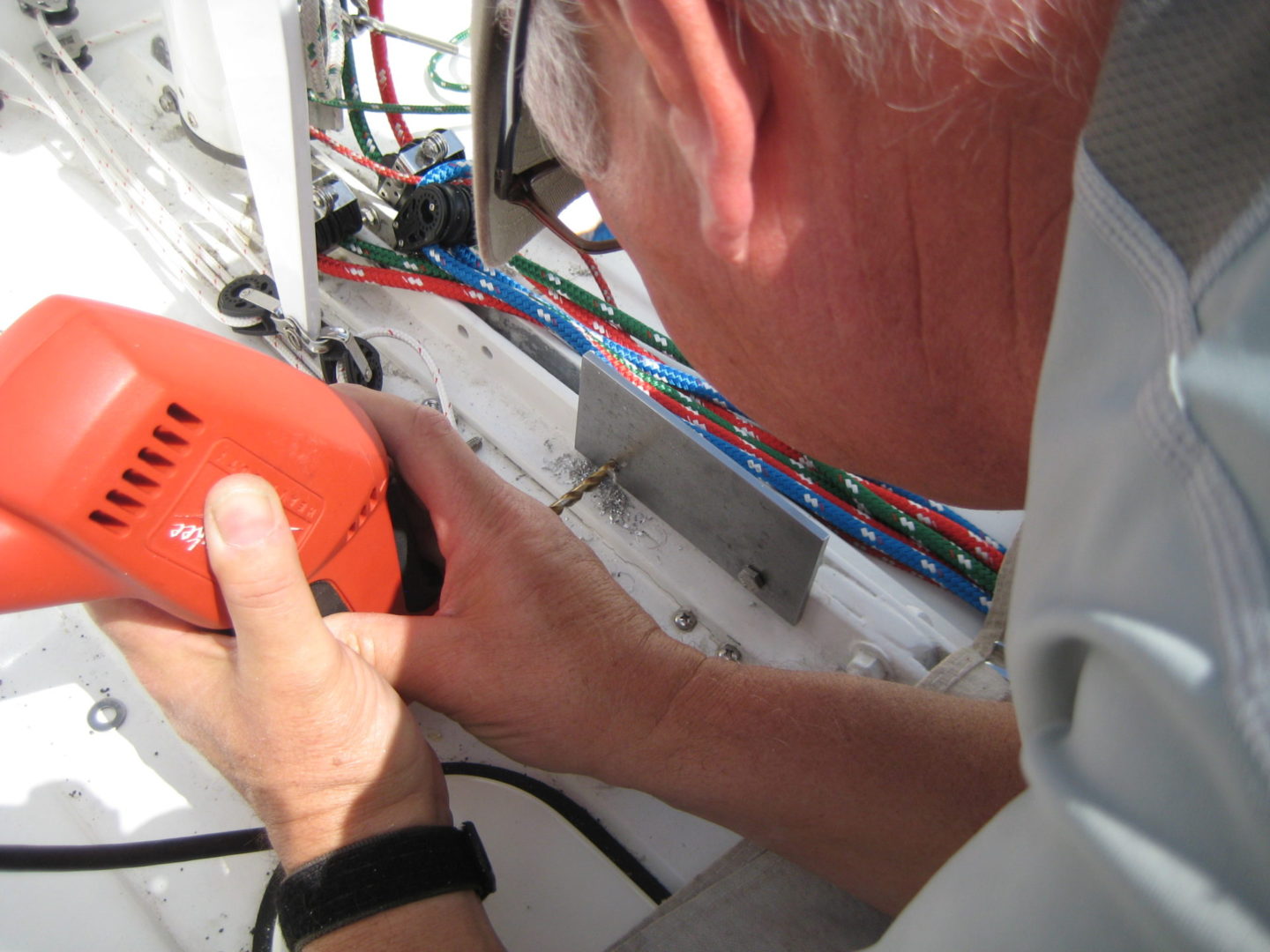 A man holding an orange device in his hands.