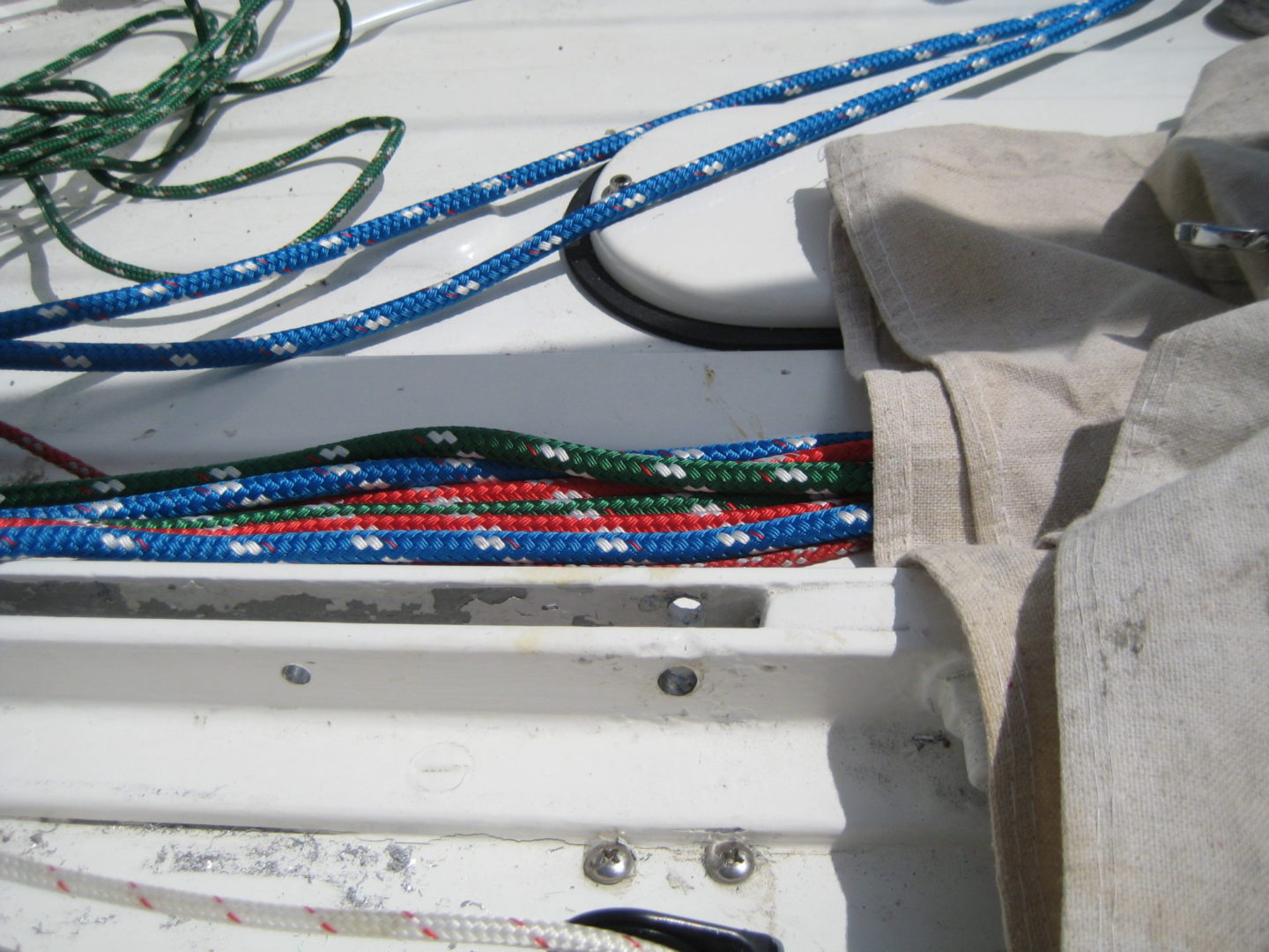 A bunch of ropes are tied to the side of a boat.