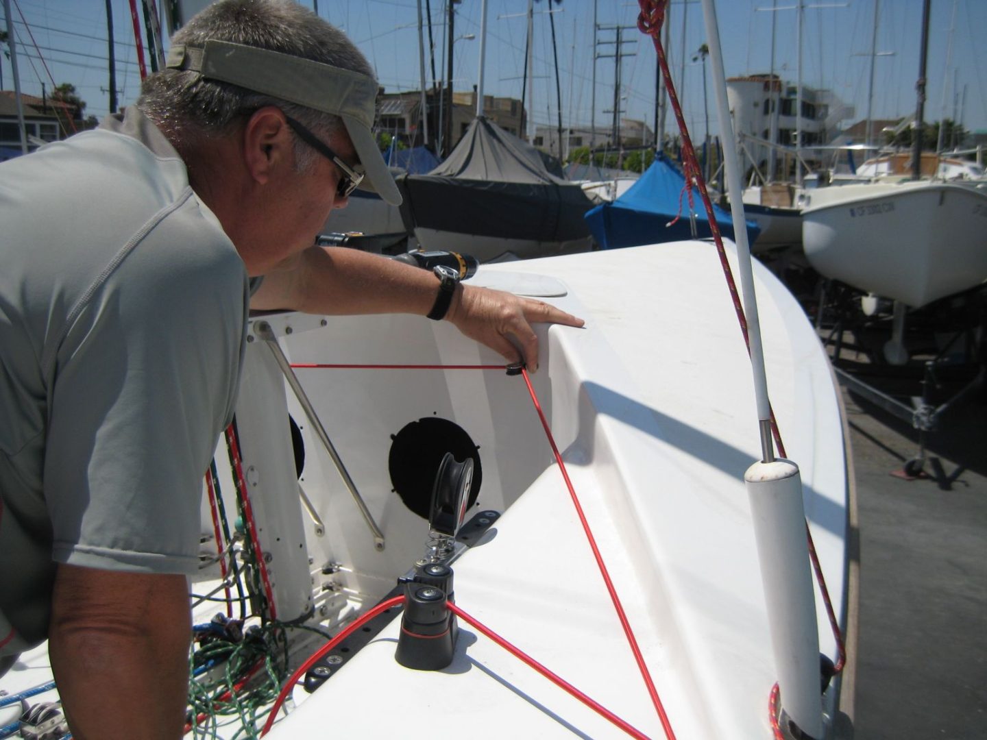 A man is working on the side of a boat.