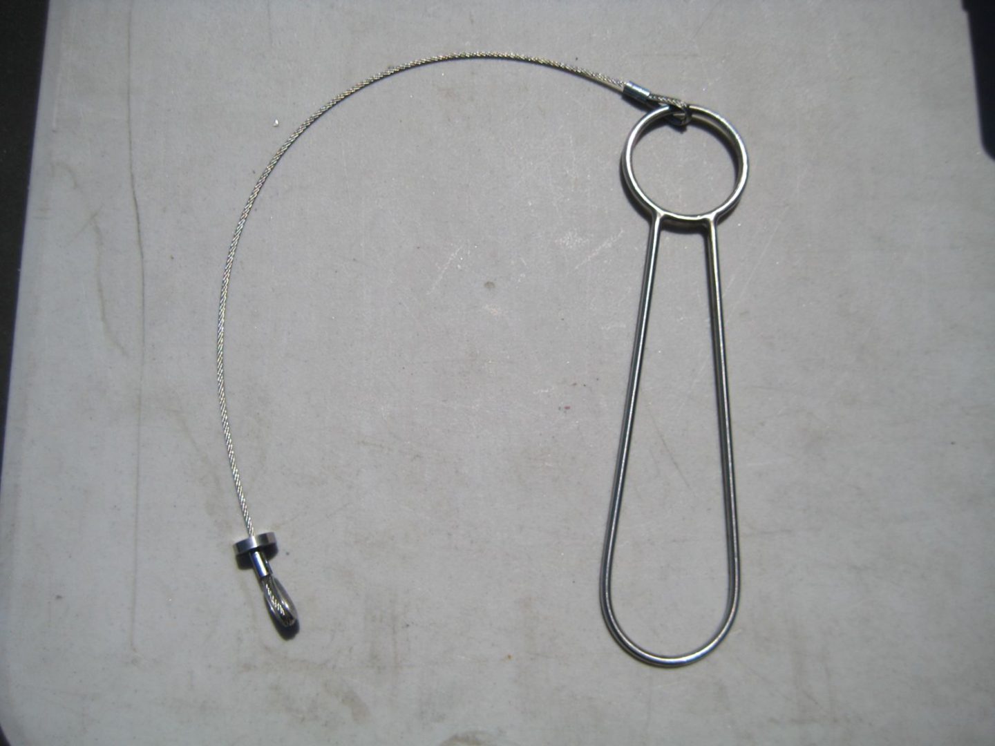 A metal wire loop with a key chain attached to it.