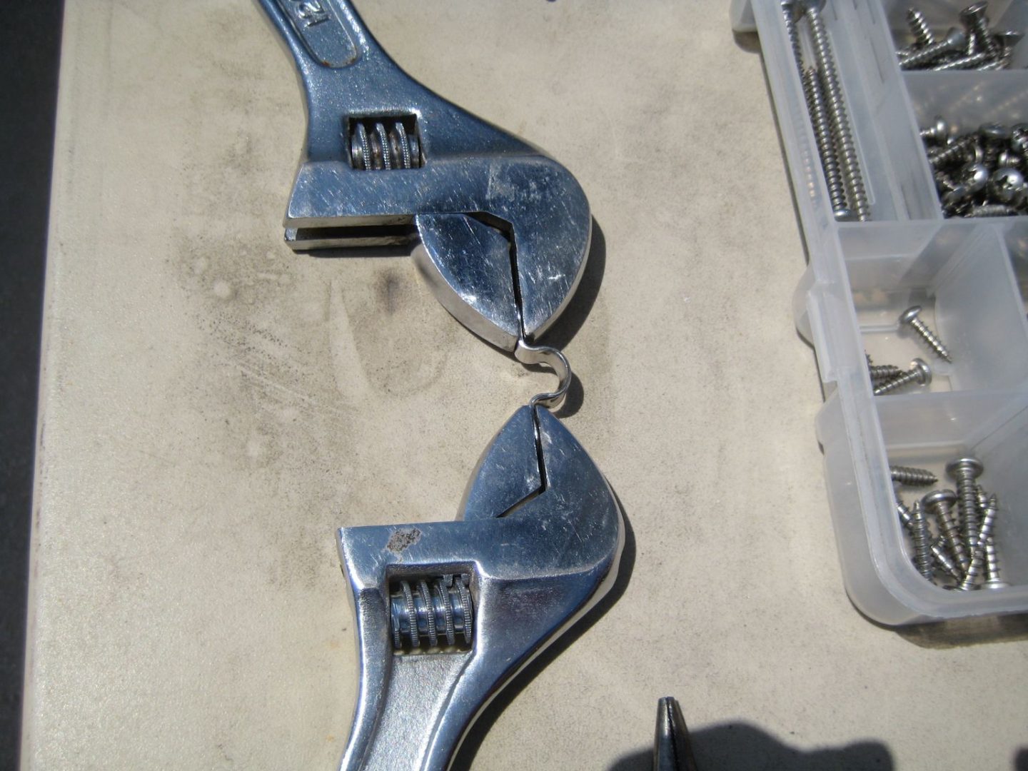 A pair of wrenches are attached to the ground.