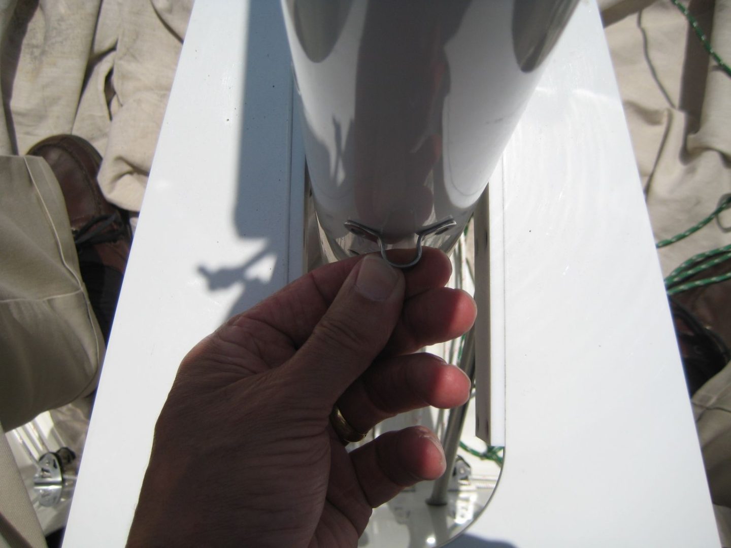 A person holding onto the handle of a glass vase.