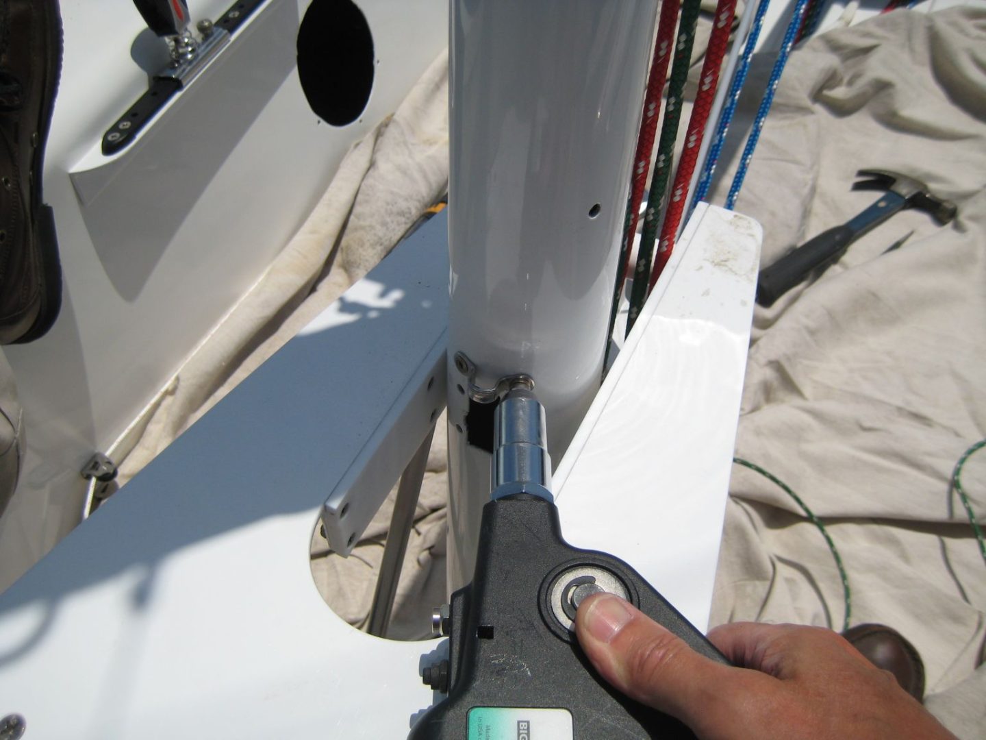 A person cutting the side of a sailboat