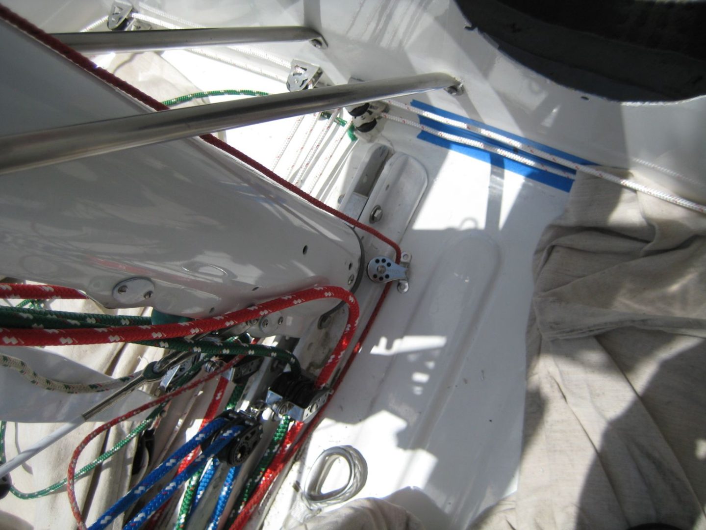 A bunch of wires are hanging on the side of a boat.