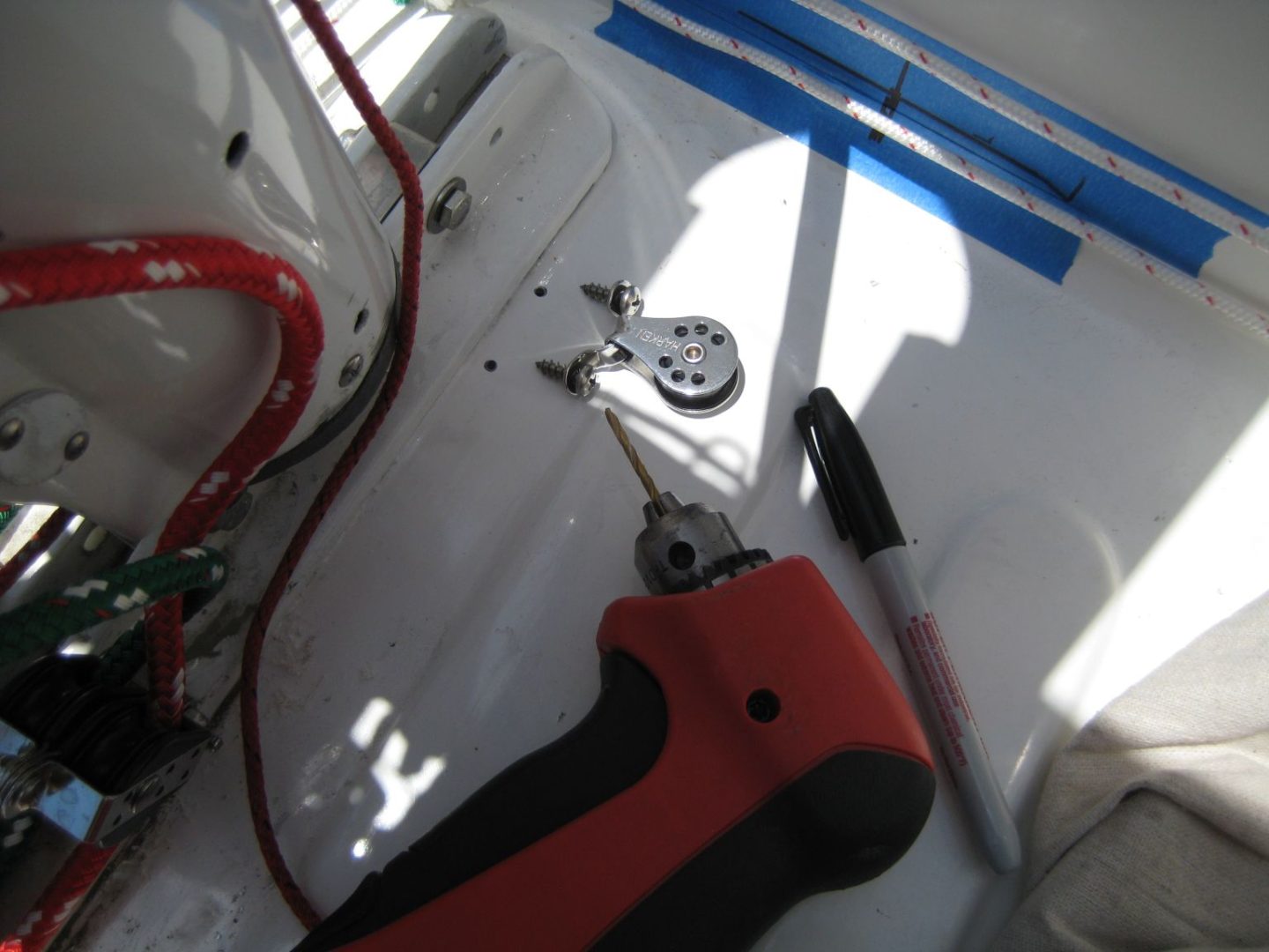 A red and black tool sitting on top of a table.