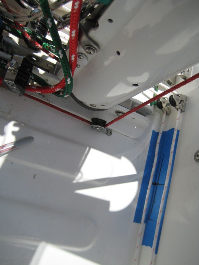 A view of the inside of a boat with blue and white poles hanging from it.