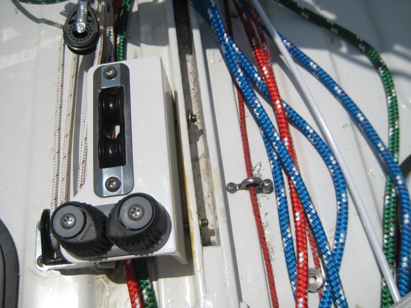 A close up of ropes and wires on the deck.