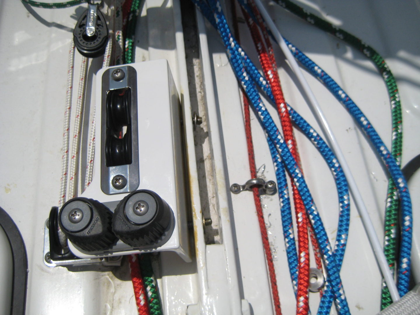 A bunch of ropes are tied to the side of a boat.