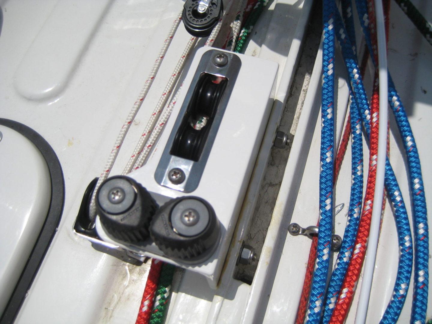 A close up of the side of a boat with ropes