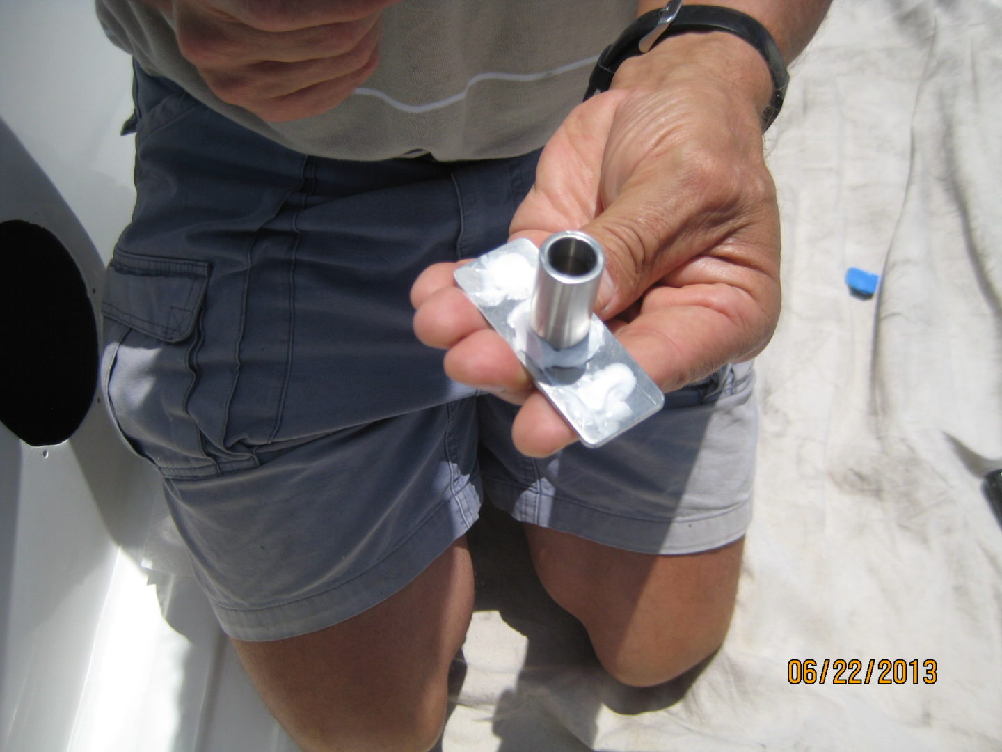 A man holding an aluminum tube in his hand.