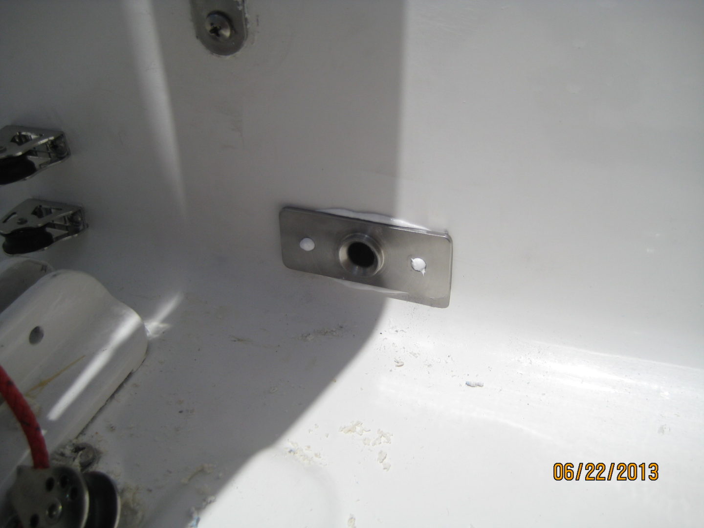 A metal plate with holes in it next to the sink.