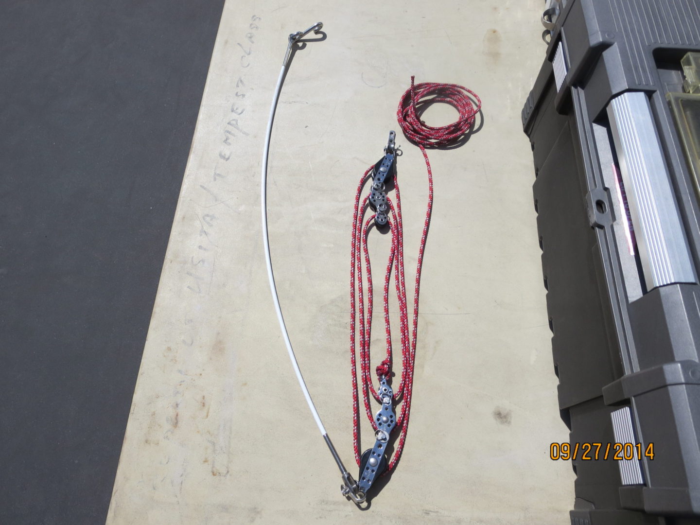 A rope and two large hooks on the floor.