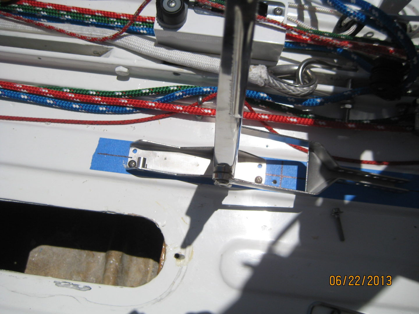 A close up of the side of a boat with wires attached to it.