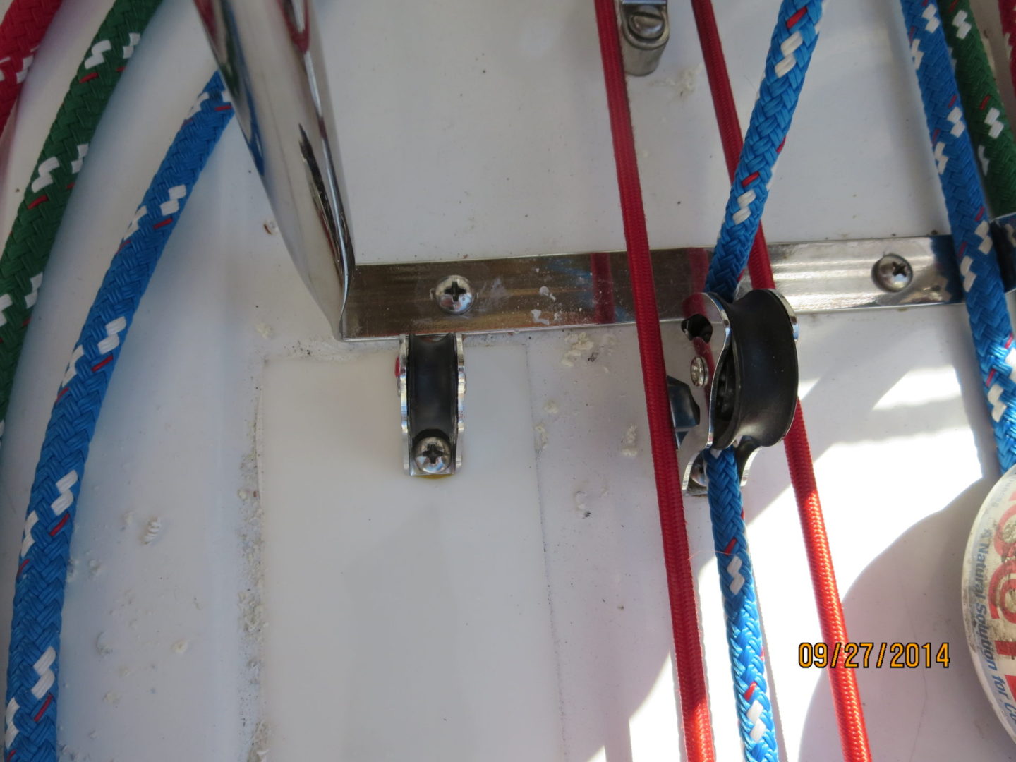 A close up of the door and window hardware on a boat.