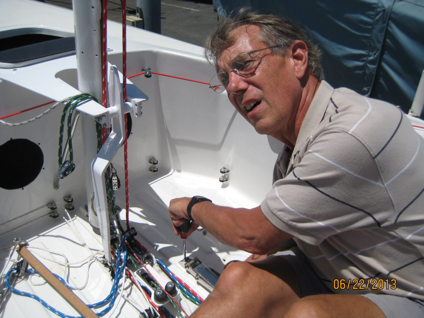 A man working on the wires of a boat.