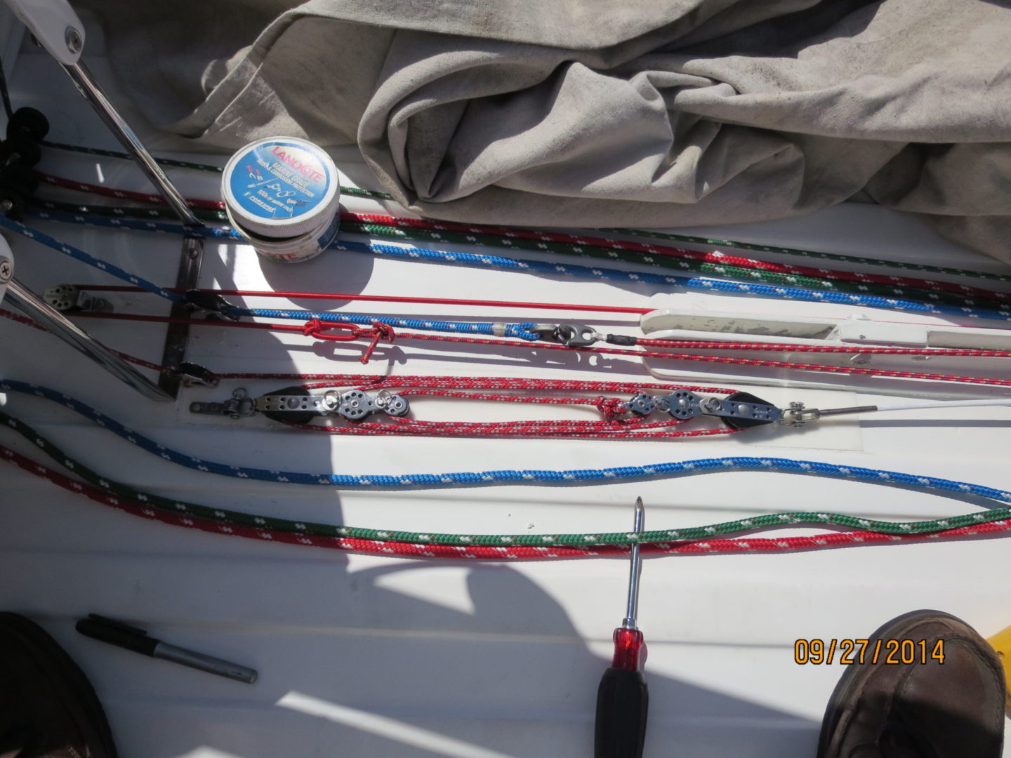 A bunch of ropes are laying on the deck