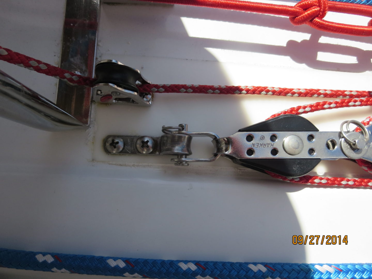 A close up of the rope and a winch on a boat.