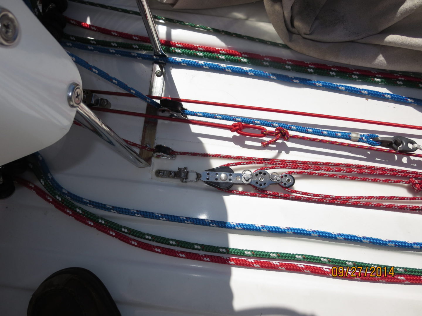 A bunch of ropes are on the deck of a boat.