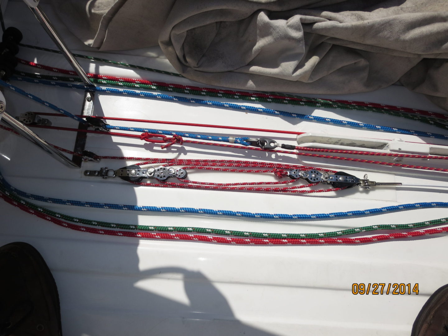 A bunch of ropes are on the side of a boat.