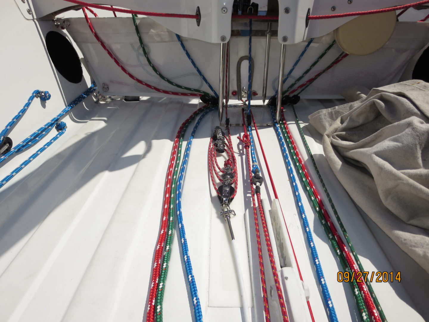 A boat with many ropes on the deck.