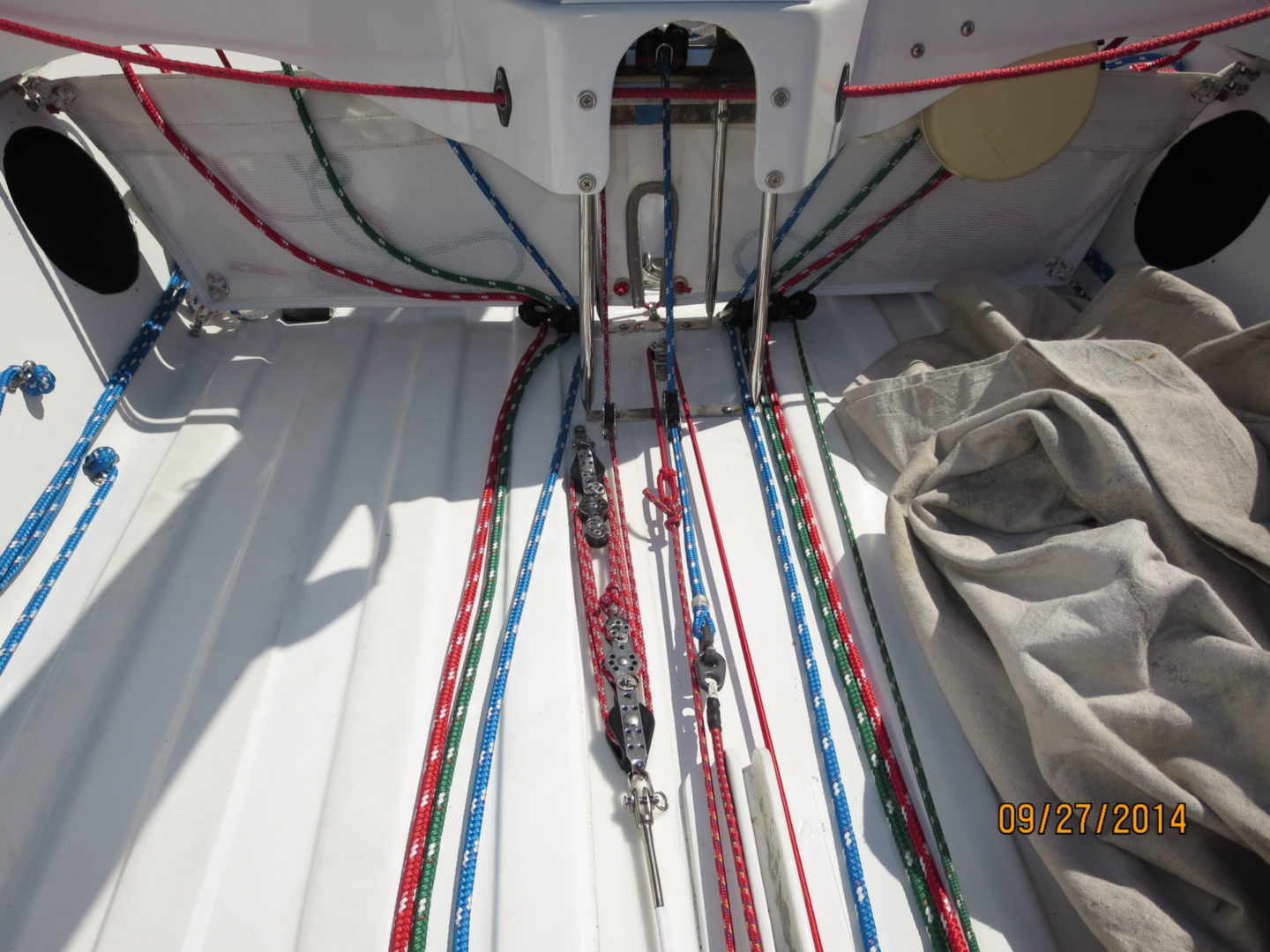 A boat with many ropes on the deck