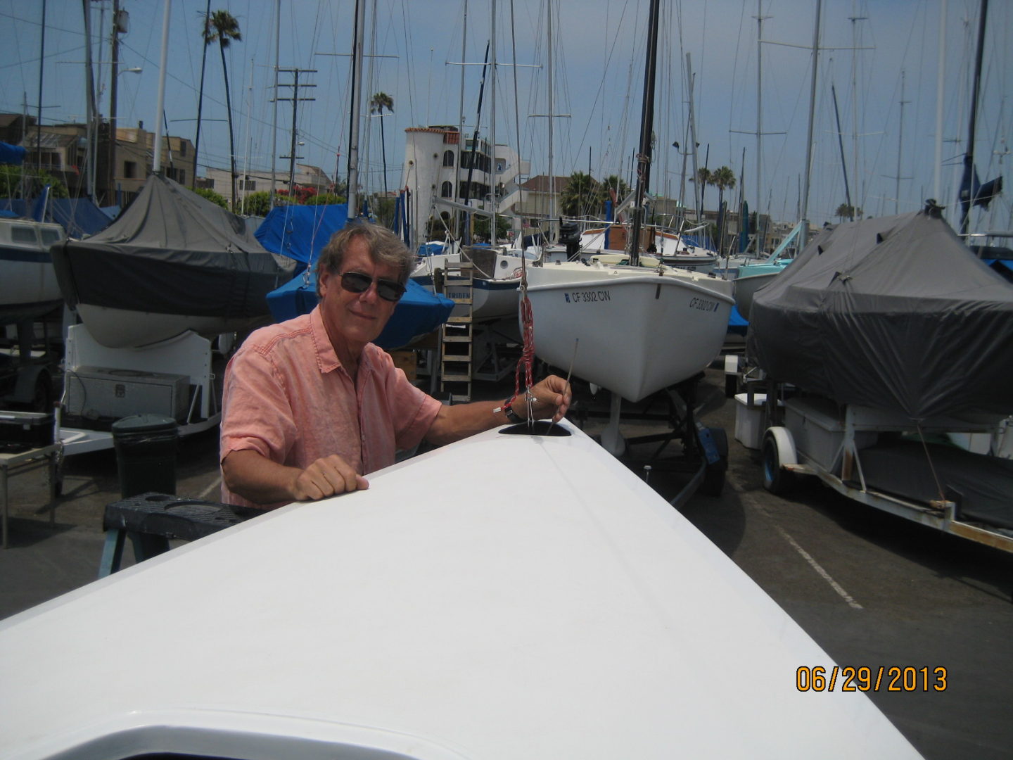 A man sitting on top of a boat in the water.