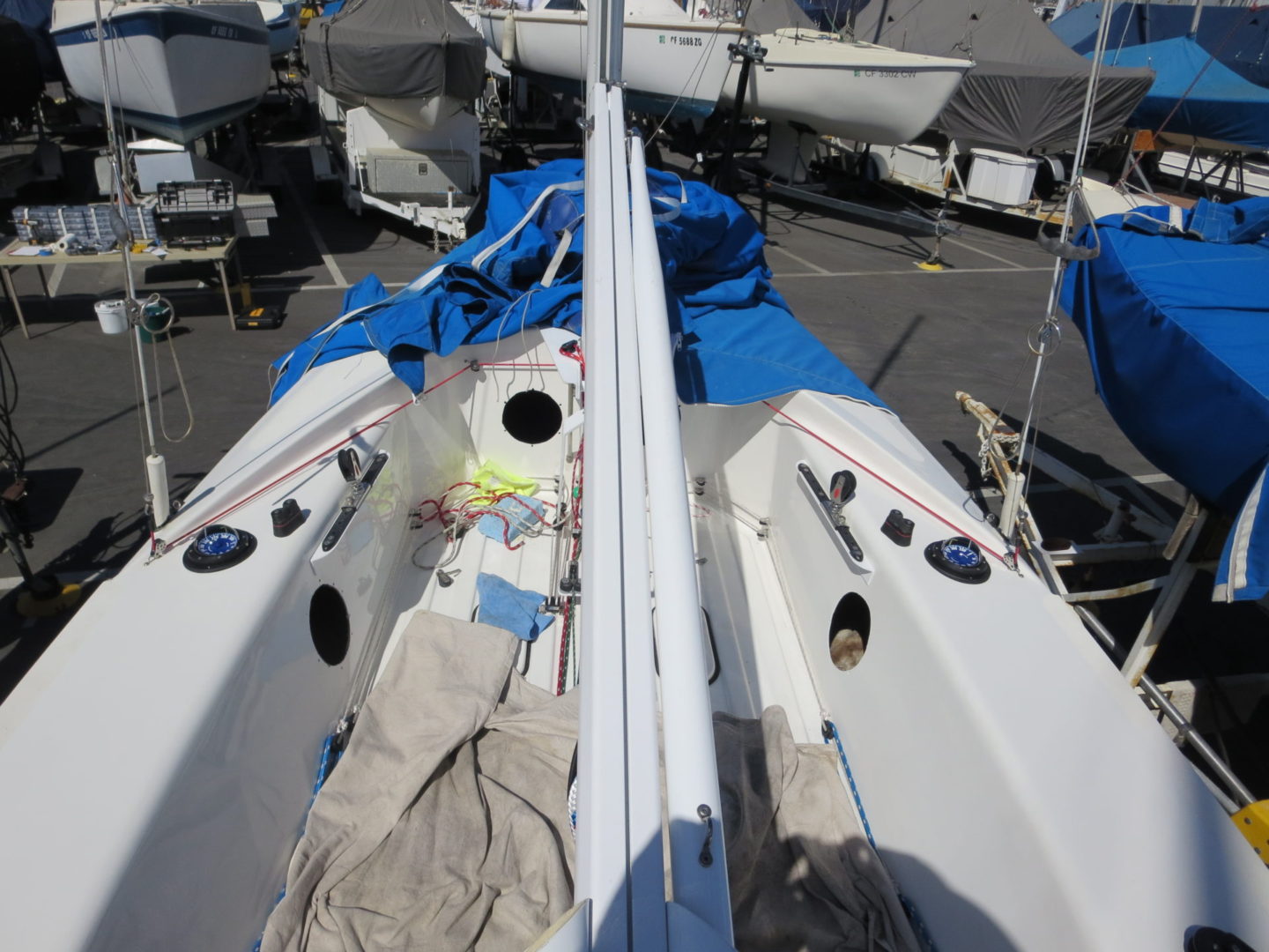 A boat is parked in the dock with some blue tarps.