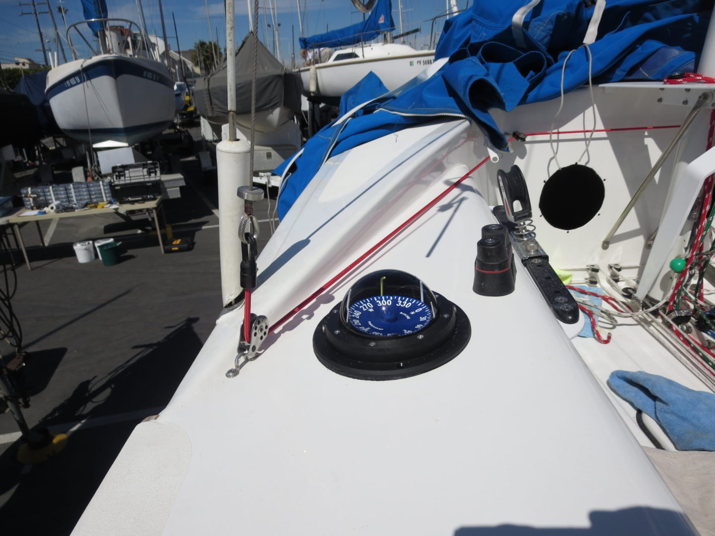 A boat with blue and white sails on the water.