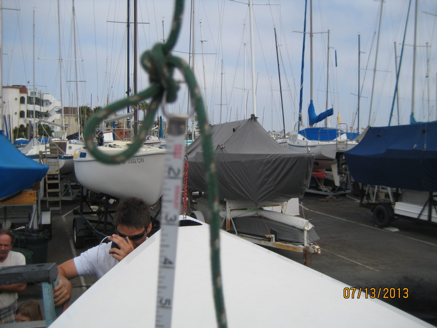 A man is standing on the side of a boat.