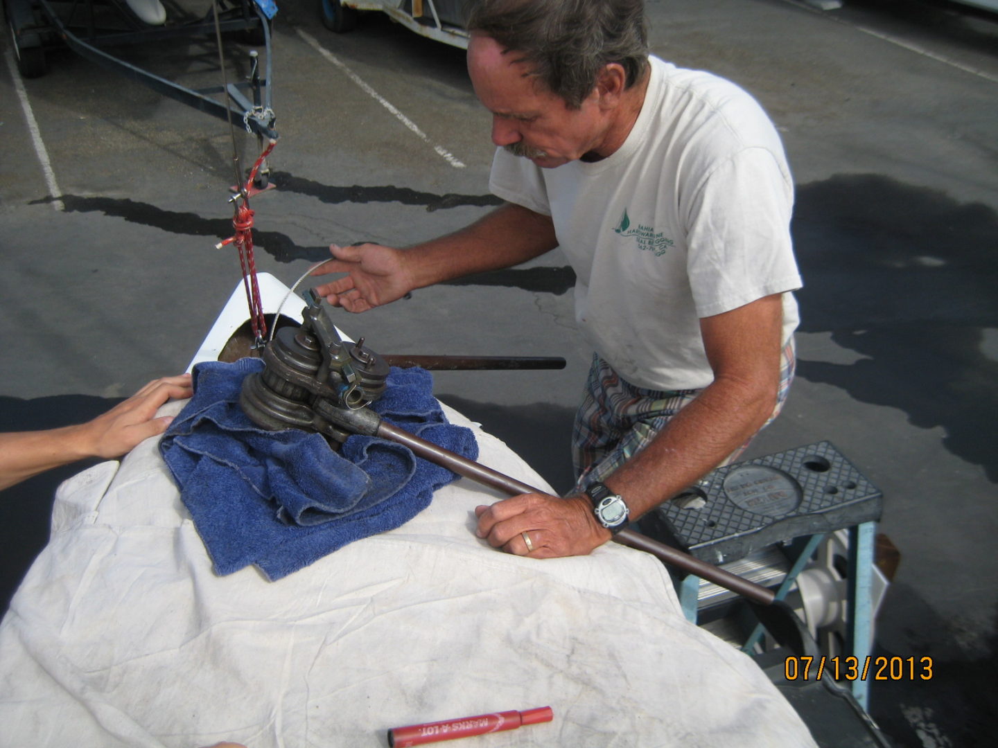 A man is working on something with some kind of tool.