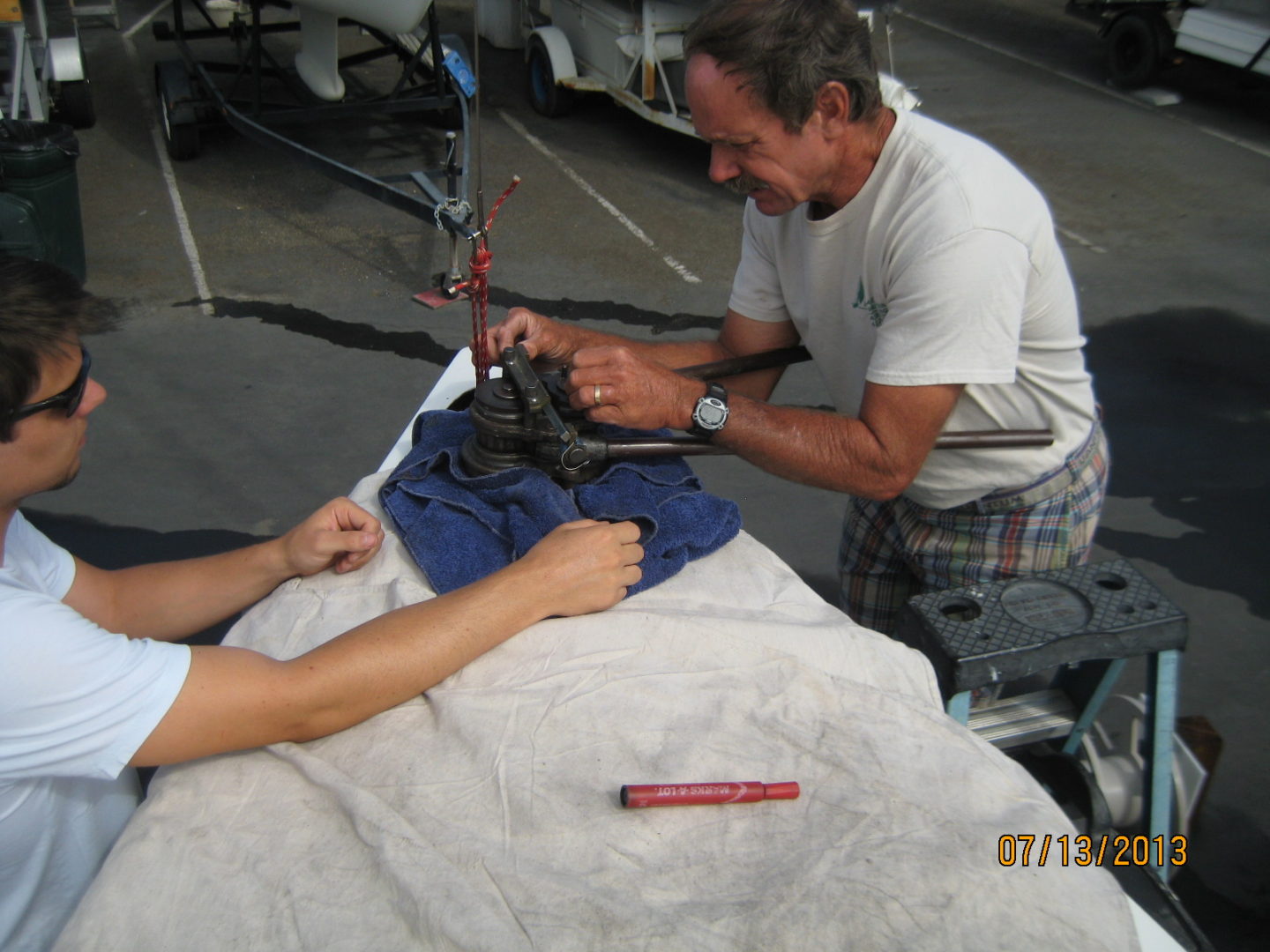 A man is sitting on the ground and holding something