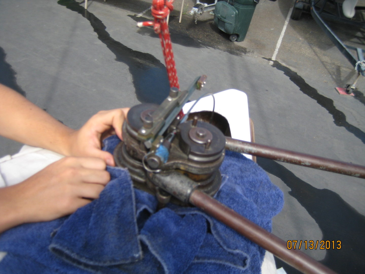 A person holding an old camera with wires attached to it.