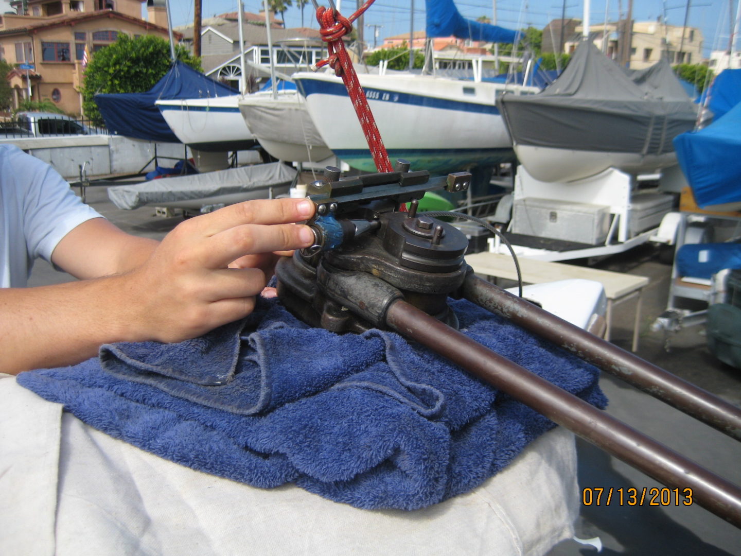 A person is working on a boat in the water.