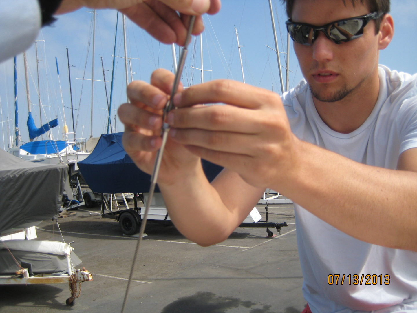 A man is holding a string and looking at it.