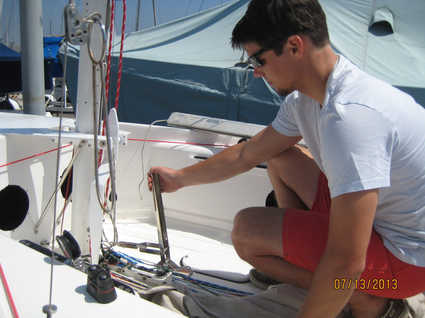 A man sitting on the deck of a boat.