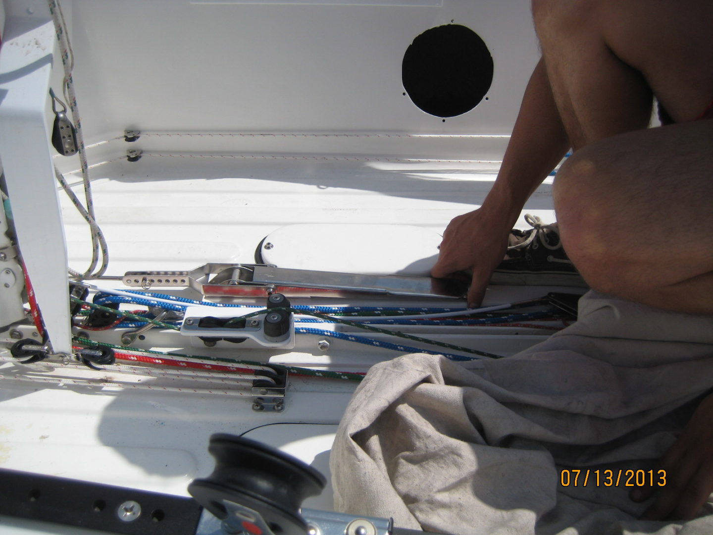 A man working on some ropes in the water.