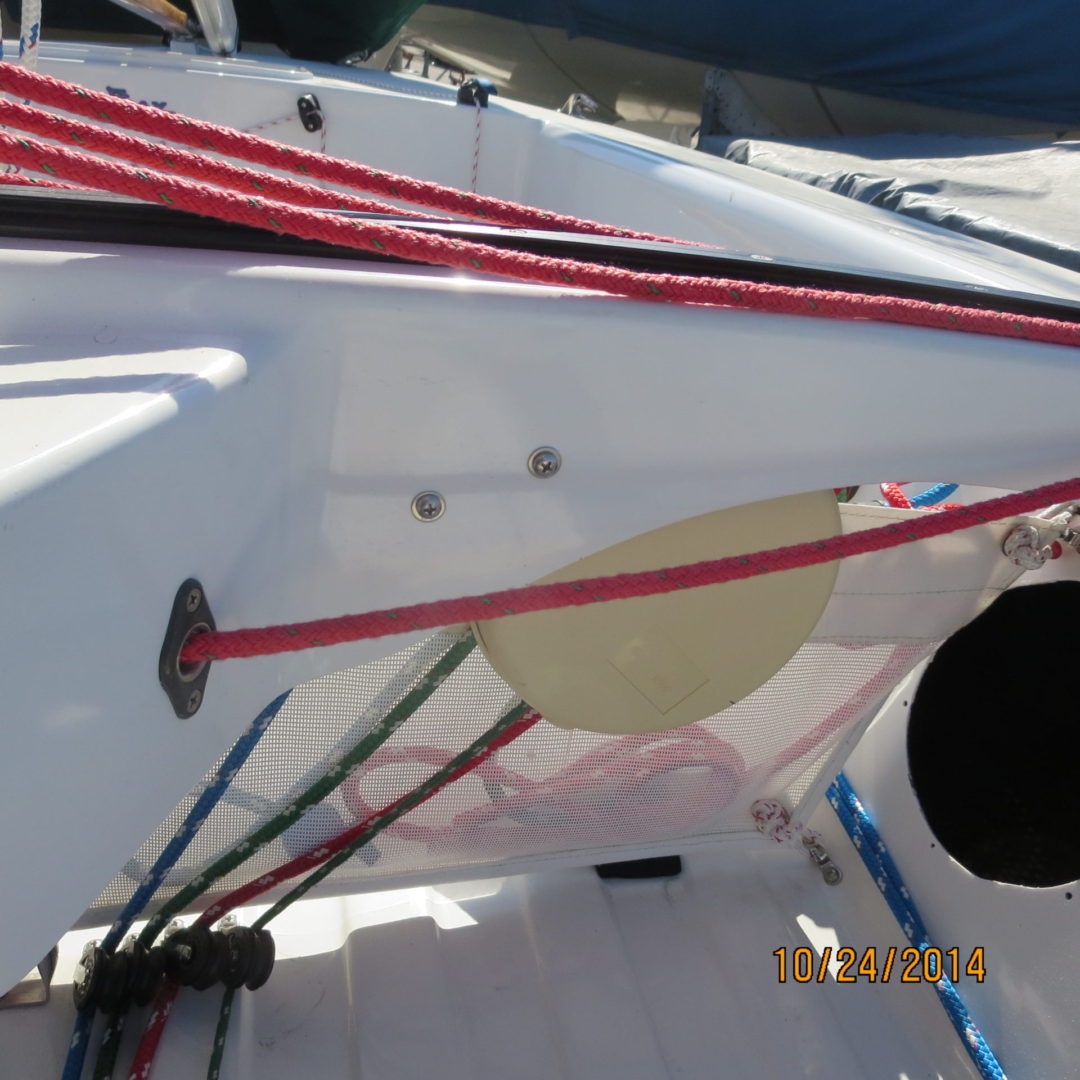 A boat with red and white ropes on the deck.