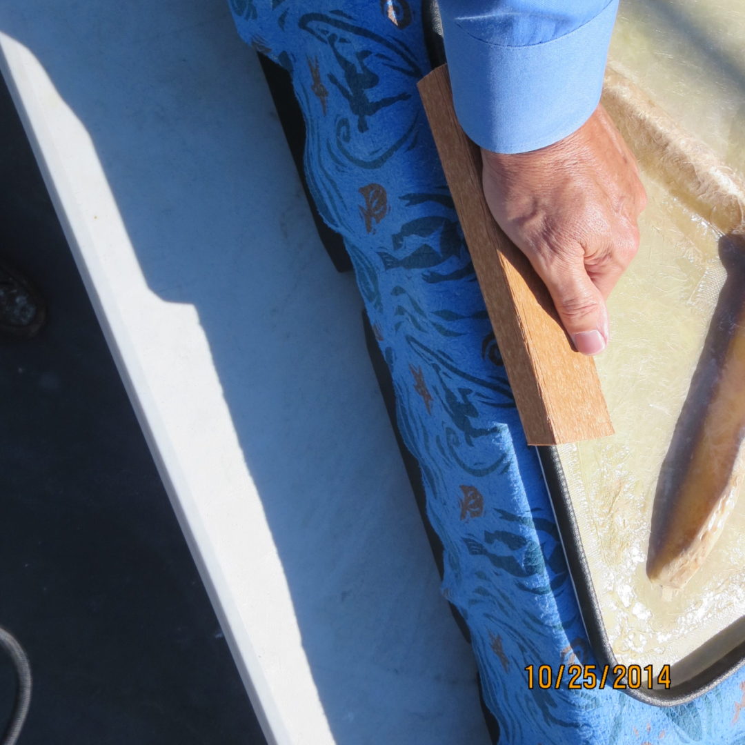 A person holding onto the edge of a boat