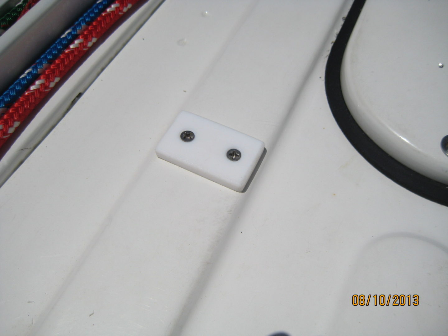 A white piece of plastic with two holes in it.