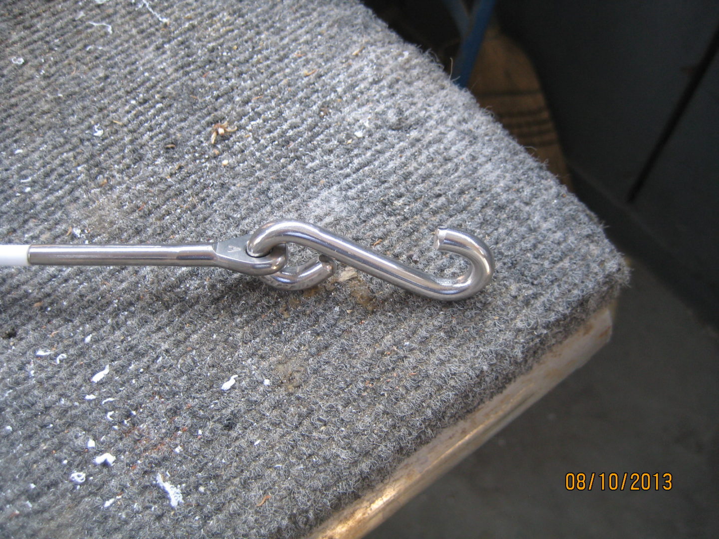 A metal hook is sitting on the ground.