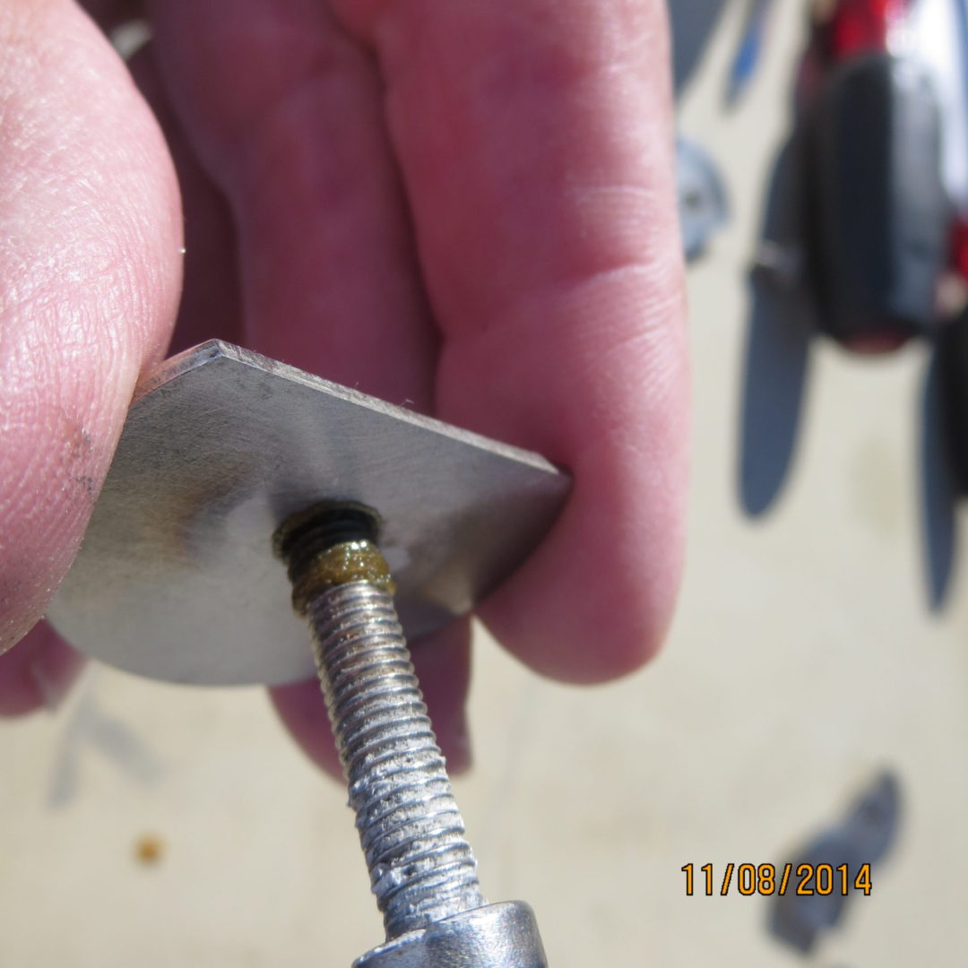 A person holding onto the tip of an airplane propeller.